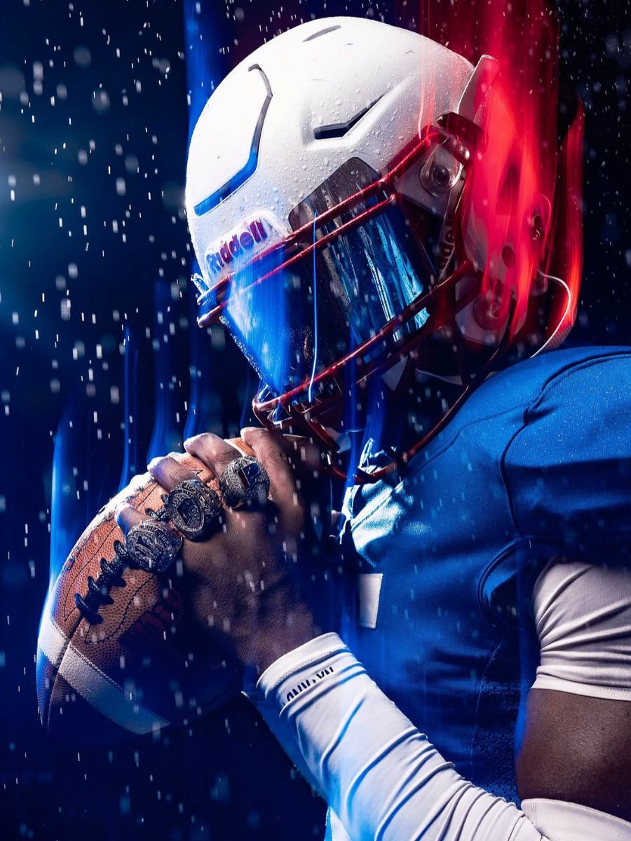 Game Day Creative — football player holding a football with championship rings