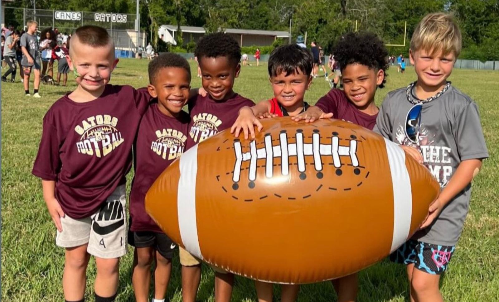 Gators campers with a team football